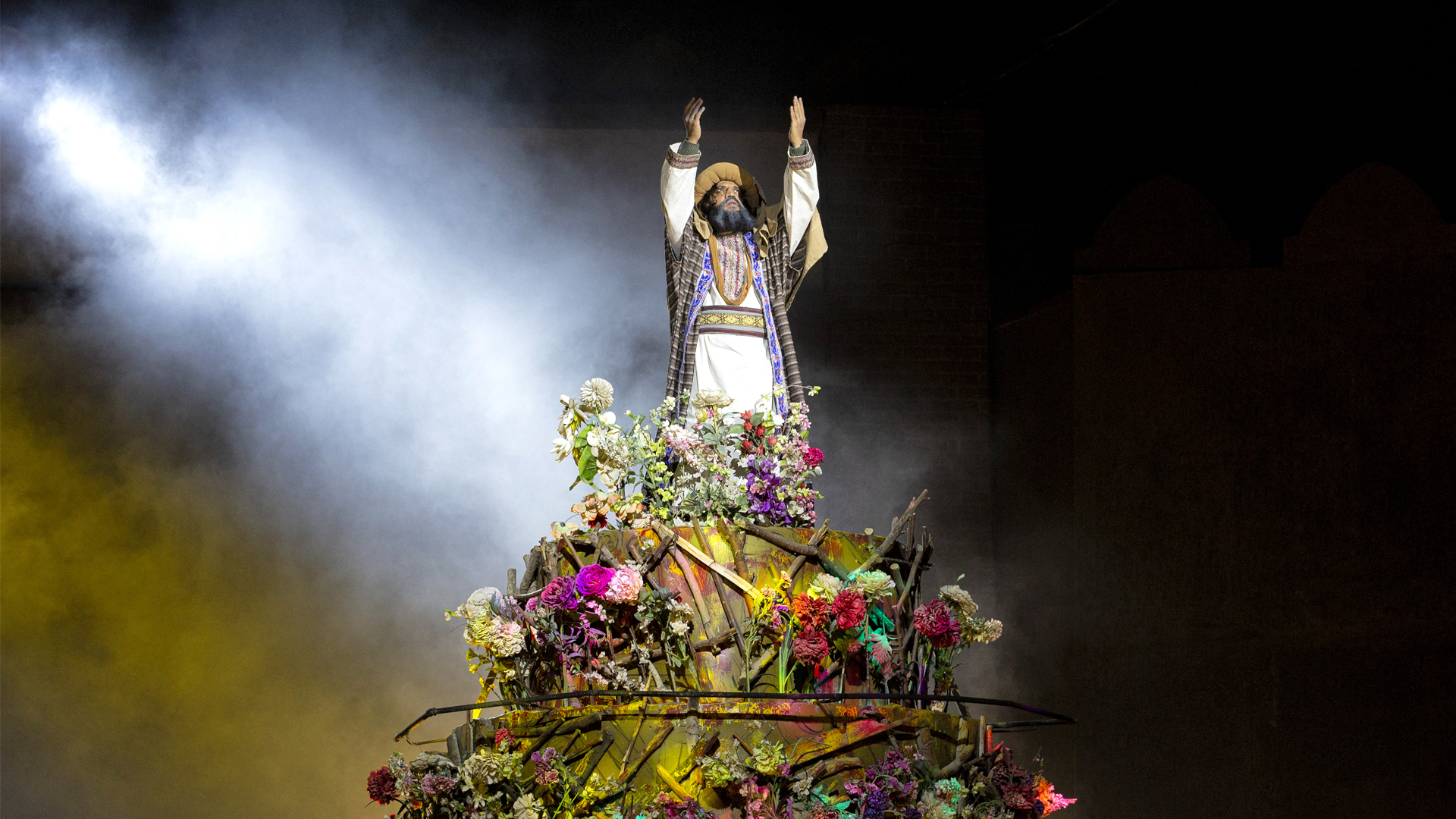 An actor in the role of the Prophet Abraham enacts a scene from a play titled 